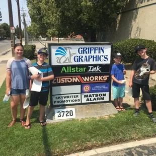 The crew installing the new Allstar Ink sign.