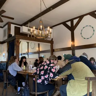 people sitting at tables in a restaurant