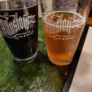 two glasses of beer on a counter