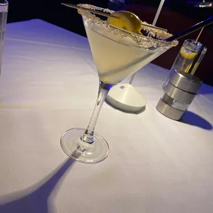 a martini in a martini glass on a table