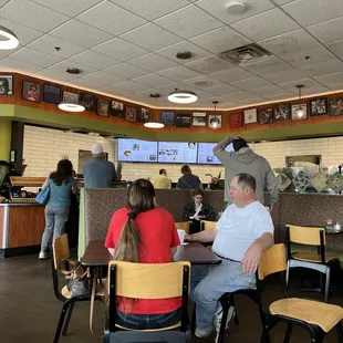 people sitting at tables in a restaurant