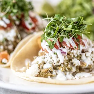 Chicken tinga verde tacos with chicken chorizo, pico de gallo &amp; crema.