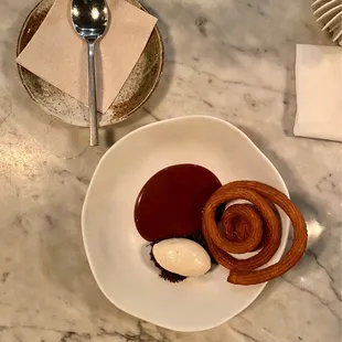 Churro curl with chocolate sauce and vanilla ice cream
