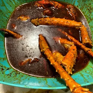 a bowl of cooked crab legs