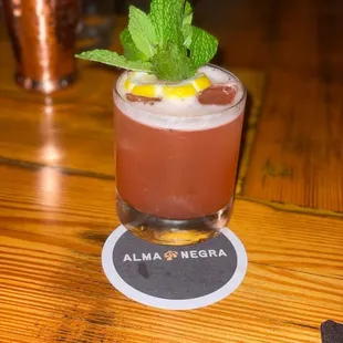 a drink in a glass on a table