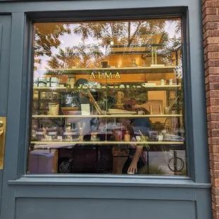 the reflection of a man in the window