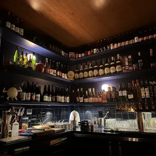 a bar with shelves full of liquor bottles