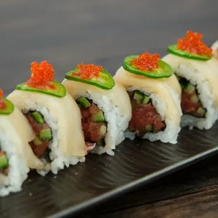 Unleash your wild side with our Tiger Eye roll!  A fusion of flavors--creamy crab, spicy tuna, and a hint of tangy sauce.