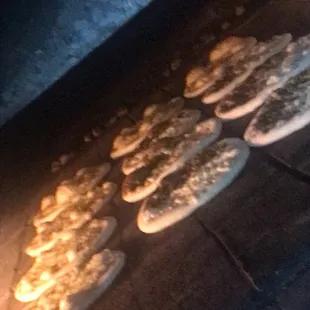 a bunch of pizzas cooking in an oven