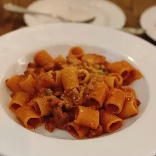 a plate of pasta with meat and cheese