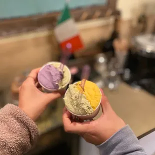 two hands holding ice cream