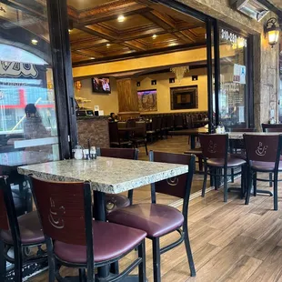 the inside of a restaurant with tables and chairs