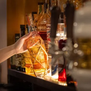 a person holding a bag of liquor