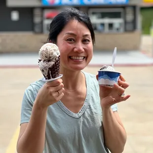 Double scoop in a chocolate dipped waffle cone and single scoop in a cup.