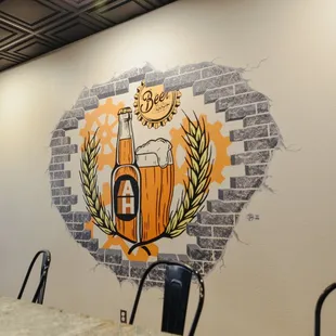 a mural of a beer bottle on the wall