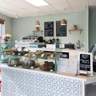 a bakery counter with a variety of pastries