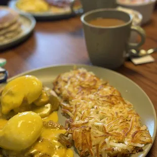 Chicken eggs Green Chili Benedict and pancake stack with eggs, bacon and hash browns.