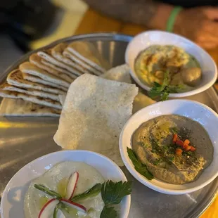 Assortment of dips - edamame hummus, smoked eggplant, spicy feta