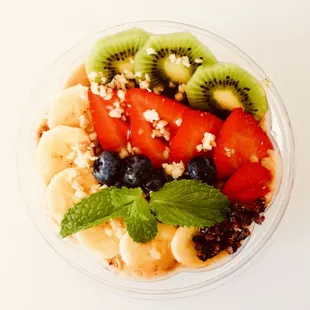Lilikoi (passionfruit) Bowl with Lots of fresh fruits and granola on the top.