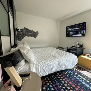 Comfy bed, smart TV, mini fridge, UBS next to bed for chargers, coffee/creamer and coffee maker and a complimentary bottle of water.