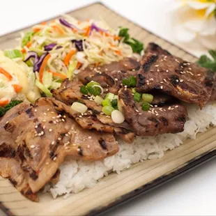 a plate of rice, meat, and vegetables