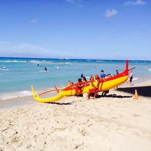 Everyone push canoe back on beach