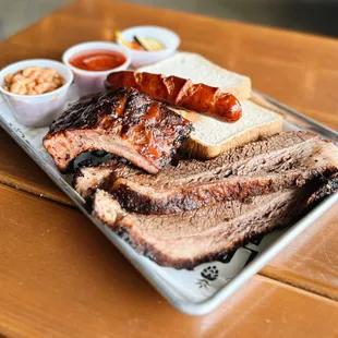 SUMMER BBQ SPECIAL: BBQ COMBO PLATE
1/2 lb brisket, 1/4 rack ribs, sausage, texas toast, baked means, pickled veggies, BBQ sauce / ketchup
