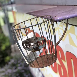 a coffee cup in a birdcage