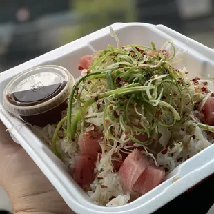 a person holding a container of food