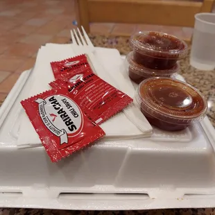 two packets of barbecue sauce and a fork