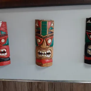 three totems on a wall