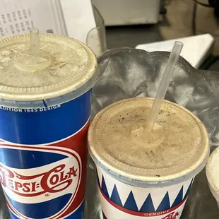 Size example cups on the main counter, covered in a thick layer of dust. This was found on various surfaces around the main kitchen space.