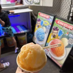 Kids size shave ice with lilikoi (passion fruit), mango, and POG syrups, plus ice cream on the bottom