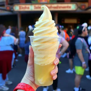 a person holding a cone of ice cream
