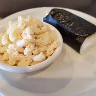 a bowl of macaroni salad and a roll