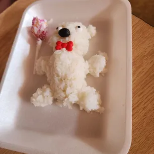 a plate of rice with a teddy bear on it