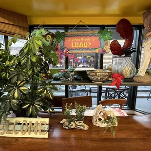 a table with plants and a sign
