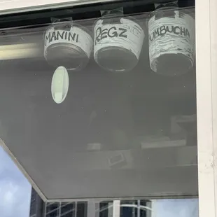 three buckets of ice cream on a window sill