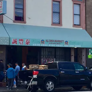 a pickup truck parked in front of a store