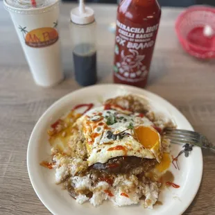 Loco Moco with burger patty and over medium eggs.