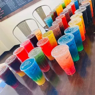 a row of different colored drinks