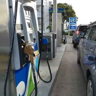 a gas pump and a car at a gas station