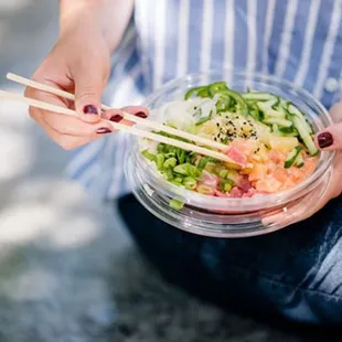 a person holding a bowl of food