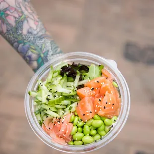 a person holding a bowl of food