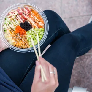 a person holding a bowl of food