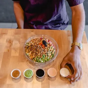 a person preparing a bowl of food
