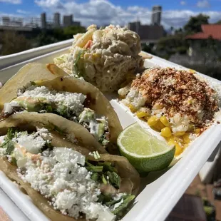 a hand holding a tray of food
