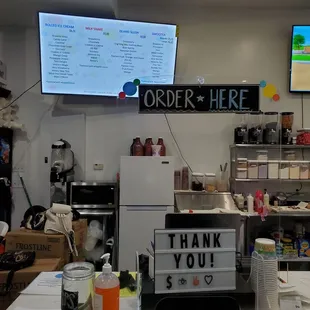 a counter with a sign that says order here