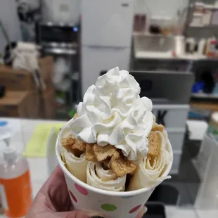 a person holding a cup of ice cream