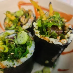 three sushi rolls on a plate